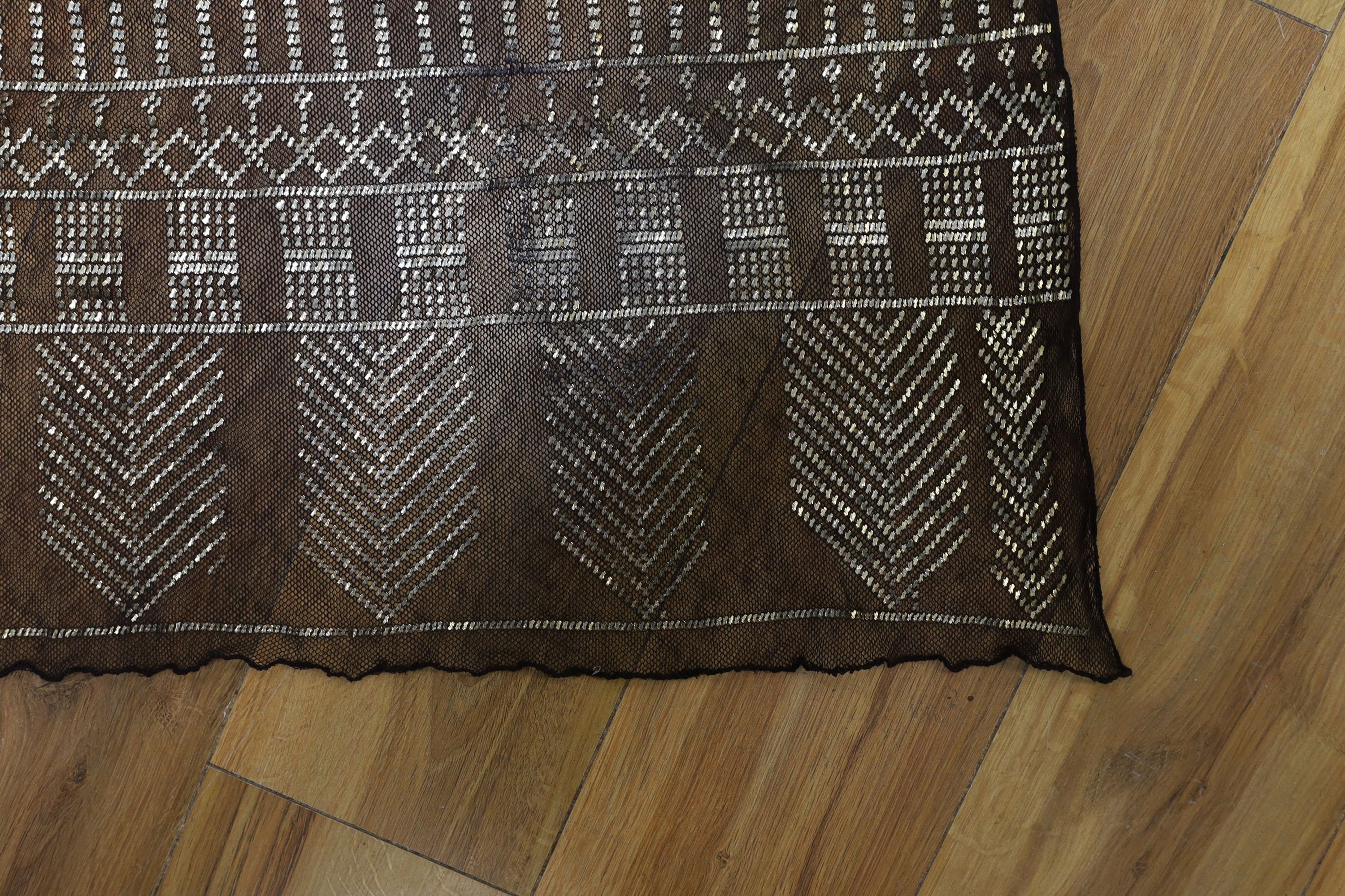 A dress made from a metal and black net Egyptian shawl; a similar shawl and a piece of shawl